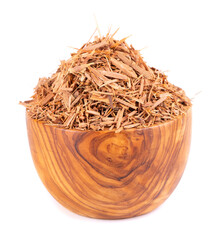 Catuaba bark in wooden bowl, isolated on white background. Trichilia catigua bark. Chuchuhuasha,...
