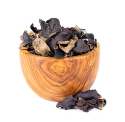 Dry black fungus in wooden bowl, isolated on white background. Chinese black mushroom or tree black muer mushroom. Auricularia polytricha.