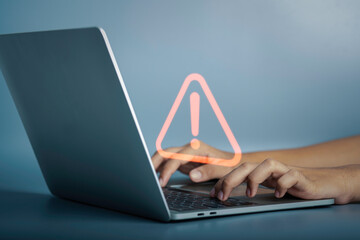 Triangle caution warning sign on laptop screen and Businessman or it staff , programmer, developer...