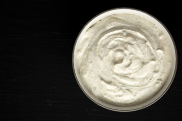 Homemade Ranch Dressing in a Bowl on a black background, top view. Flat lay, overhead, from above. Space for text.