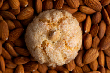 Top close up view of a pardulas biscuit with almond as a background