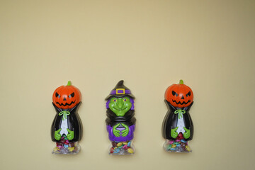 Cute character in monster costume. Scary Halloween figurines stand on a light background in close-up