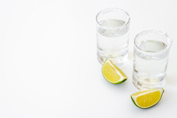 Tequila with lime and salt in glasses, top view