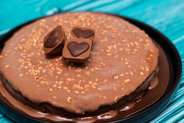 Delicious chocolate layer cake with toffee heart. On wooden rustic table