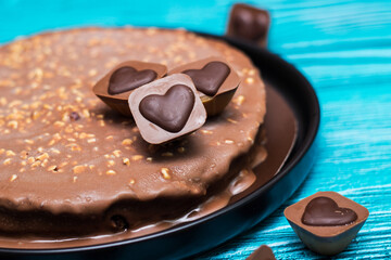 Delicious chocolate layer cake with toffee heart. On wooden rustic table