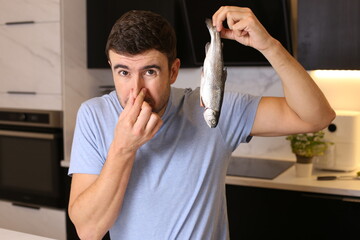 Man disliking the fish natural aroma 
