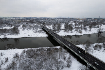 Nowohucki Bridge (Most Nowohucki) Kraków, winter time, cars crossing bridge on Vistula river, snowy day