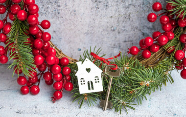 Fototapeta na wymiar Key for New House on Christmas Wreath . Buying new home for Christmas Concept 