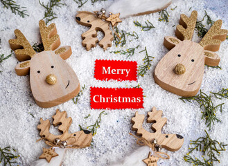 Merry Christmas greeting  card  with wooden deer 