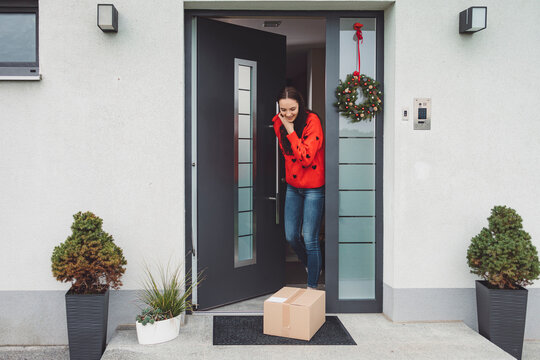 Cheerful Young Woman Exited Over A Surprise Package Waiting For Her At The Front Door 