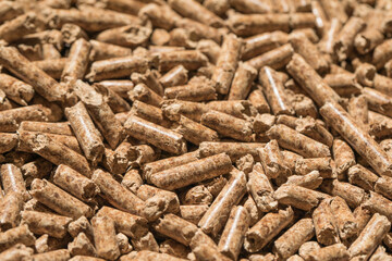 Wood pellets background, pattern. Pellets of natural wood close up. Ecological heating, energies renewable Biofuels.