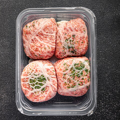 ground meat cutlet in fat grid fatty mesh pork, beef raw minced meat fresh meal food snack on the table copy space food background rustic top view