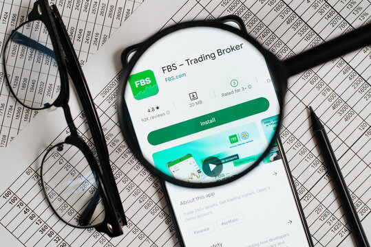FBS trading broker financial mobile application online store on smartphone at workplace. Top view, close-up, view through magnifying glass. Astana, Kazakhstan 12.12.2022