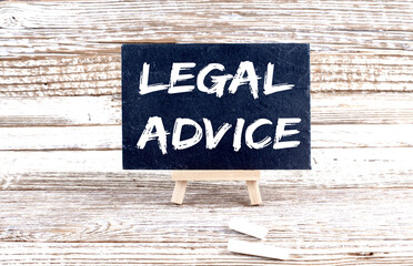 LEGAL ADVICE text on the Miniature chalkboard on wooden background