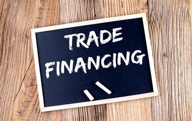 TRADE FINANCING text on a chalkboard on the wooden background