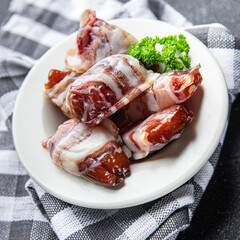 dates in bacon snack smoked meat dry-cured meal food snack on the table copy space food background rustic top view