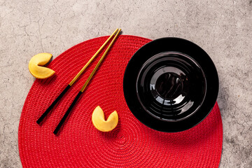 Black and gold chopsticks with red mat. Asian tabble place setting