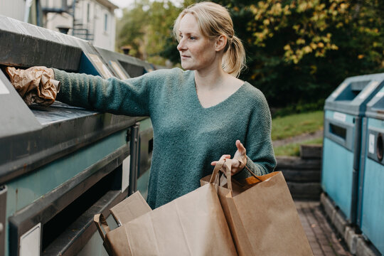 Woman recycling rubbish