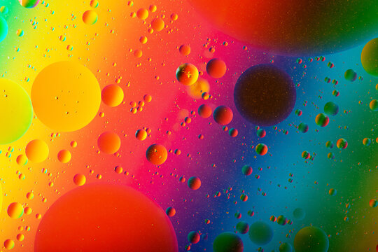 Macro photography of the oil drops on the water surface.Cosmic circles looks like molecule structure.Backdrop with copy space,good as template.