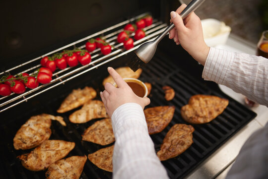 Putting marinade on meat