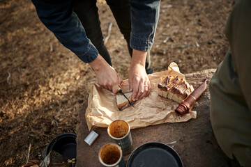 Hands cutting bread