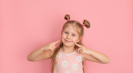 Smiling confident girl showing and pointing with fingers her lips and mouth. Smile and positive...