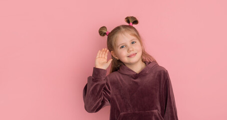 Curious girl listens. Closeup portrait of kid hearing something, gossips, hand to ear gesture isolated on pink. Human face expression, emotion, body language, life perception.