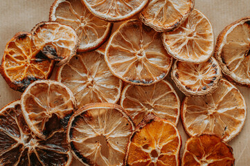 Fototapeta na wymiar Dried orange, lemon, and tangerine slices. Candied citrus fruit food background. Top view with copy space for text. Flat lay. Concept of holiday homemade craft and presents, zero waste, natural decor.