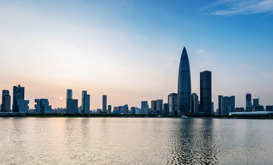 Naklejka premium Office building reflected in the water at sunset