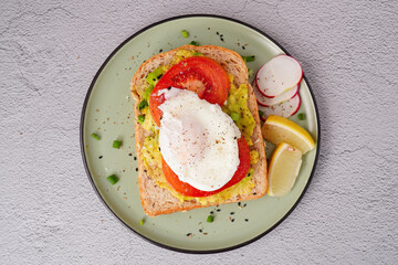 Breakfast, avocado on wholemeal bread and boiled egg on white background