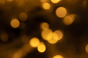 Abstract background of blurred yellow lights for design. Lights bokeh dis focus. Christmas background, copy space