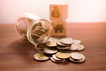Coins in a jar, close-up, money saving concept (spot focus)