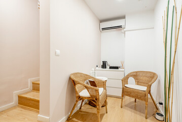 Waiting room with wicker armchairs and the need for water to prepare coffee and tea