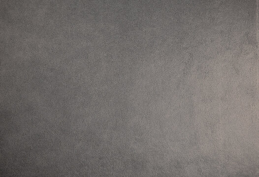Dark grey suede fabric background. Abstract texture wallpaper.