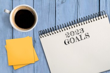 Concept of new goals on notebook and coffee cup