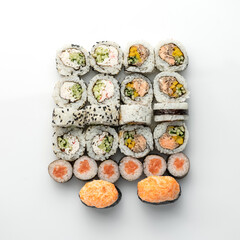 Japanese sushi rolls set isolated on white background. Healthy oriental food. Wellness concept. Flat lay. View from above. Copy space. High quality photo