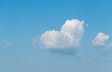 White heart shaped cloud in the blue sky