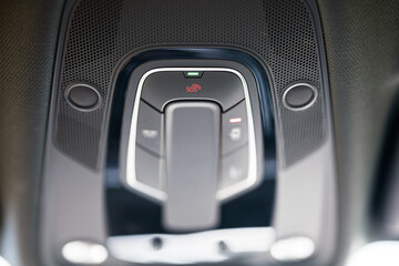 sos button located on the roof line inside a car. communication, emergency and modern technology...
