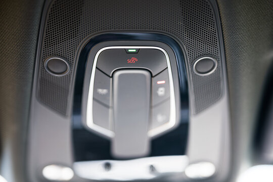 sos button located on the roof line inside a car. communication, emergency and modern technology concept.