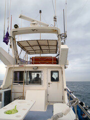 Wheelhouse  of the Japanese fishing boat. Cloudy calm sea photograph taken from the rear deck. © SAIGLOBALNT