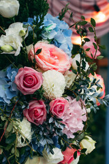 Bouquets of blue, white, pink and red flowers adorn the wedding venue at the entrance to the restaurant.