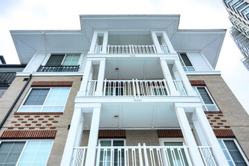 Top of residential buildings on overcast sky background