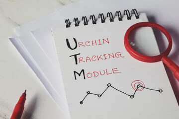 Notepad with the text Urchin Tracking Module (UTM) on desk.