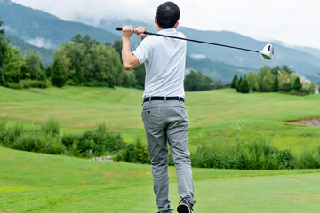 Man golf player swinging golf club