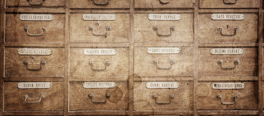 Old pharmacy cabinet with pharmacy medicines in it. Vintage medical, pharmacy and chemistry background.  Overlay effect on old paper texture. - obrazy, fototapety, plakaty