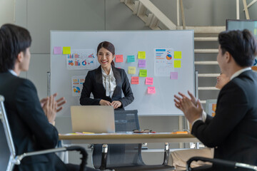 A group of young Asian businessmen Talking and planning work happily and have fun. at the company's office