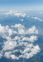 Top view cloudy mountains from a plane