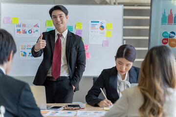 A group of young Asian businessmen Talking and planning work happily and have fun. at the company's office