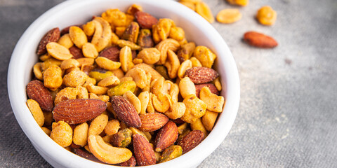 nuts mix almonds, cashews, pistachios, peanuts fresh healthy meal food snack on the table copy space food background rustic top view