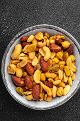 nuts mix almonds, cashews, pistachios, peanuts fresh healthy meal food snack on the table copy space food background rustic top view